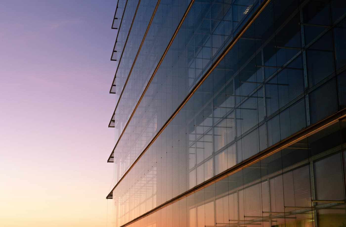 Glass office facade at dusk